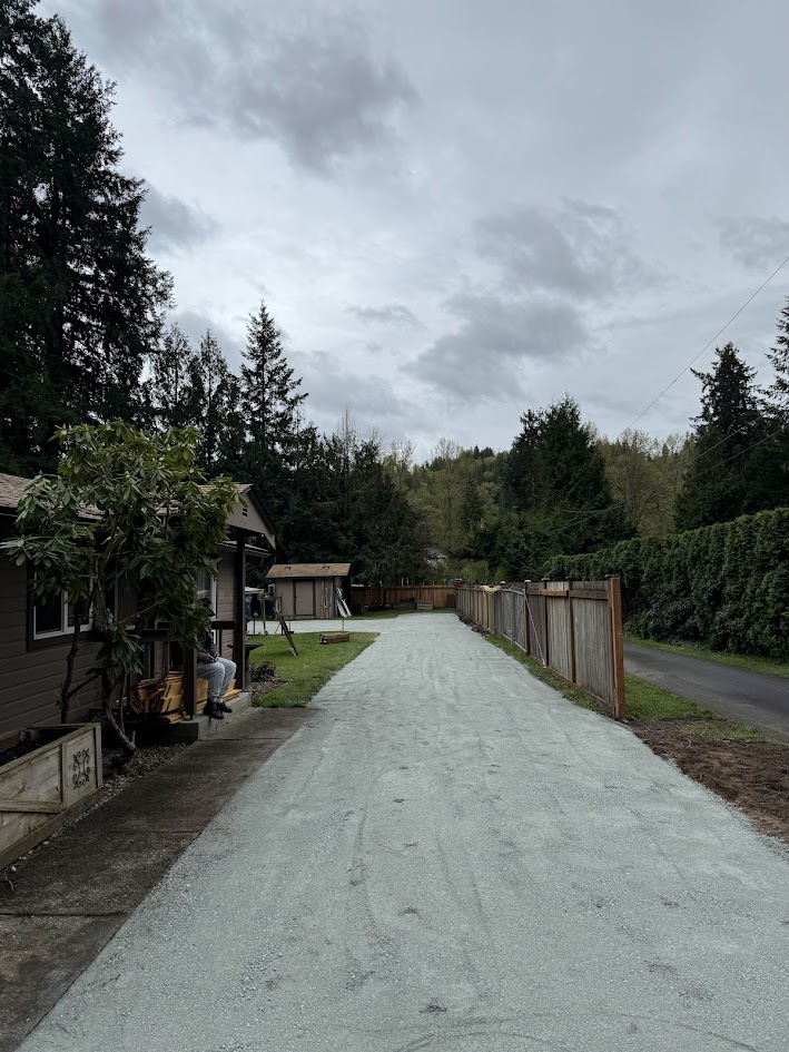 laying out the gravel for the gravel driveway project with franky's excavation