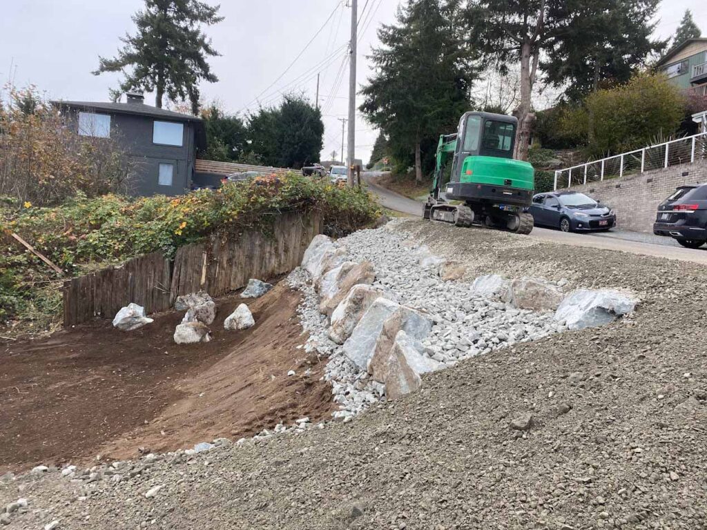 franky's excavation removing dirt and rocks from a hillside excavation project