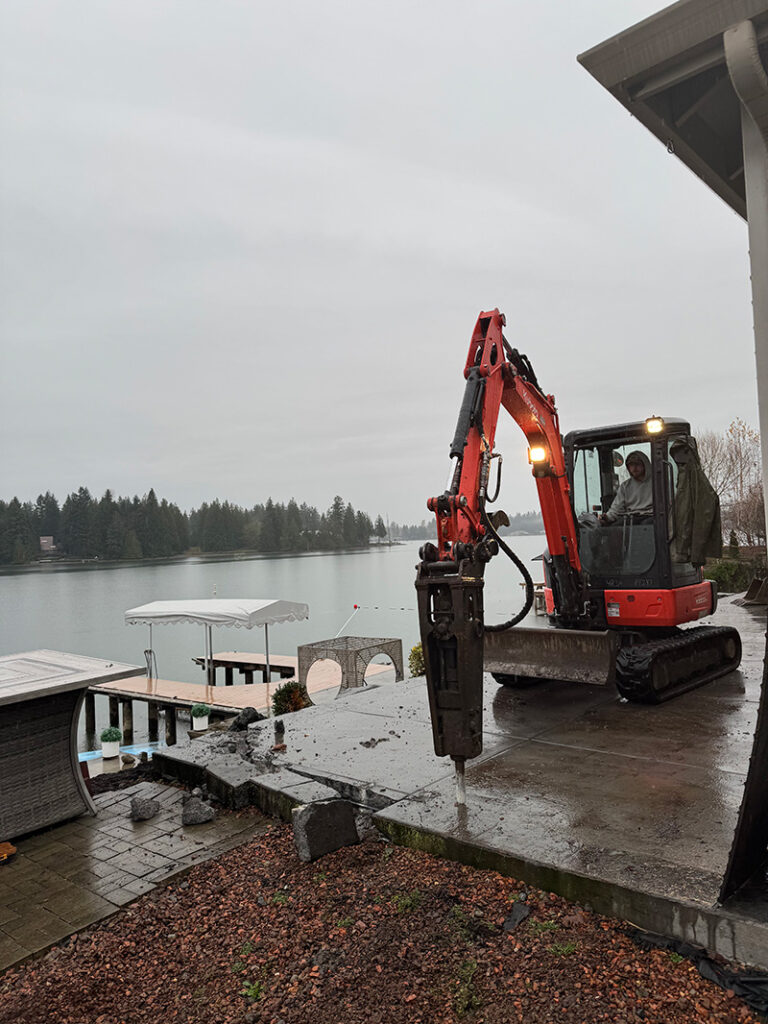 franky's excavation removing a concrete deck next to a lake