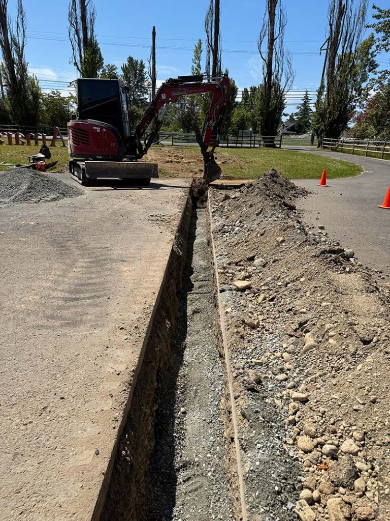 utility line trenching with concrete driveway cutting done by franky's excavation